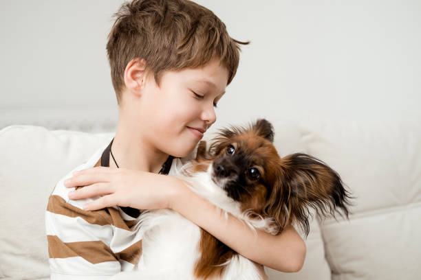 istock A happy Caucasian boy hugs his dog. 2185339729