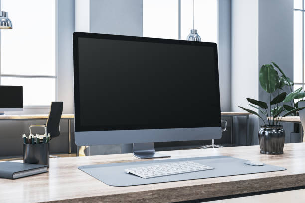 Closeup of modern desktop computer on office desk, with keyboard and mouse, in a bright workspace environment. 3D Rendering