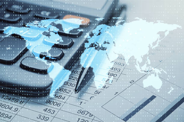 istock Calculator, pen, and world map overlay on financial data sheets, representing global business and digital accounting concepts. 2185341259