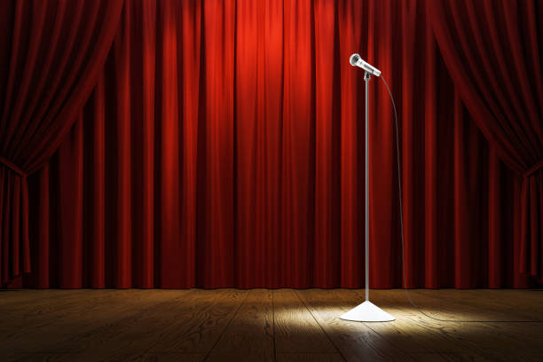 A microphone stand on stage with red curtains, spotlight focused on it, wooden floor in front, concept of comedy or concert event, empty scene. 3D Rendering.