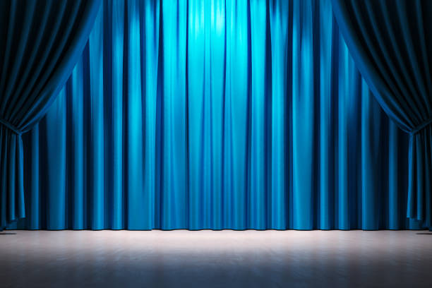 istock Closed blue stage curtains with spotlight in front view on an empty wooden floor. Blank scene for a performance or creative event backdrop. 3D Rendering 2185341336