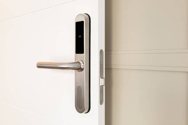 istock Open front door with electronic mortise lock and handle. The door is opened with a combination of a digital code or a plastic card. Modern door opening and property security systems. 2185342326