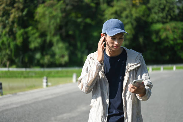 istock Young male runner checking progress on his smart phone outdoors 2185343961