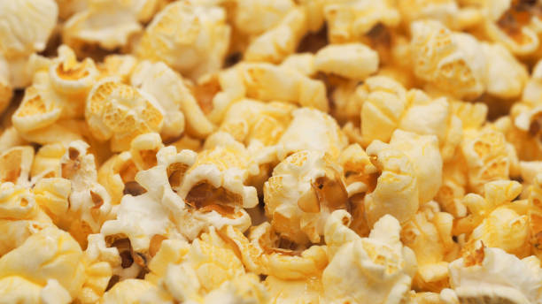 istock A scattered popcorn texture background with irregular clusters of fluffy popcorn pieces, varying in size and shape. perfect for casual or whimsical designs 2185344313