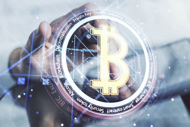 istock Double exposure of creative Bitcoin symbol hologram and hand working with a digital tablet on background. Mining and blockchain concept 2185344984