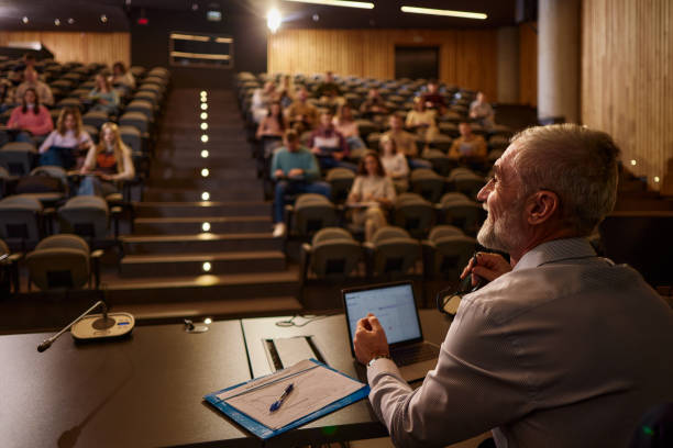 istock Happy mature professor talking on a class at lecture hall. 2185345346