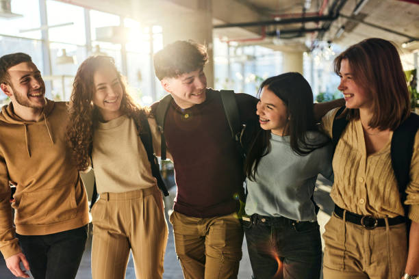 istock Happy college students walking embraced through campus. 2185345827