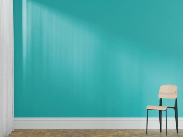 istock Minimalist interior with a chair and turquoise wall. 2185346256