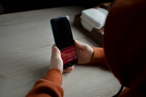 istock Telephone in the hands of a child with space for text 2185346603