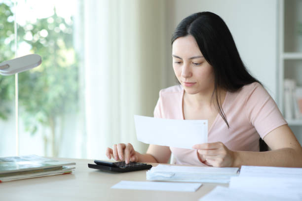 istock Asian woman calculating expenses checking bill 2185348718