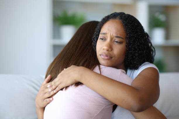 istock Sad black woman hugging her friend 2185348803