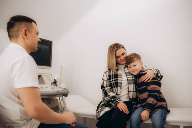 istock A mother hugs her son at the doctor's office 2185349038