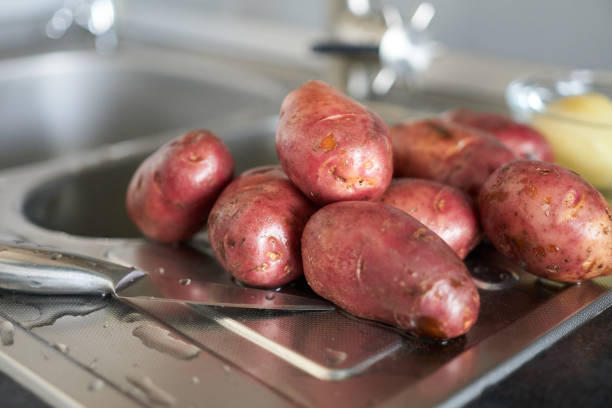 Closeup of small red potatoes on wooden cutting board