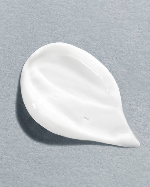 istock Moisturizing cream on a textured gray background, highlighting the creamy texture and smoothness of the skincare product 2185349518