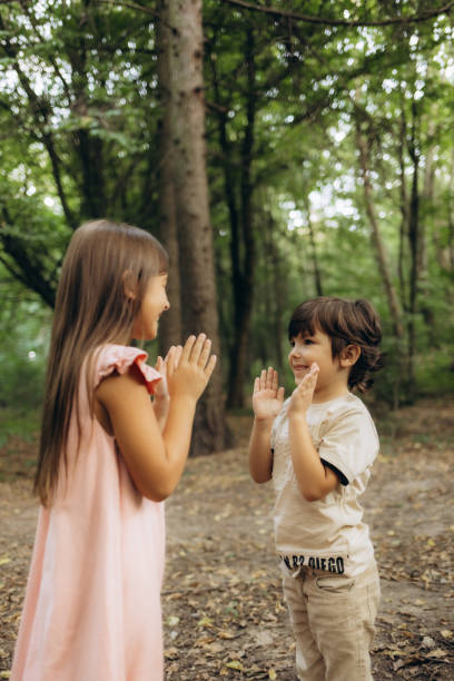 istock Brother and sister playing in the forest 2185349557