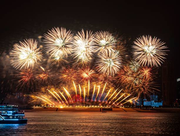 istock Tour boat fireworks illuminating city skyline at night. 2185349765