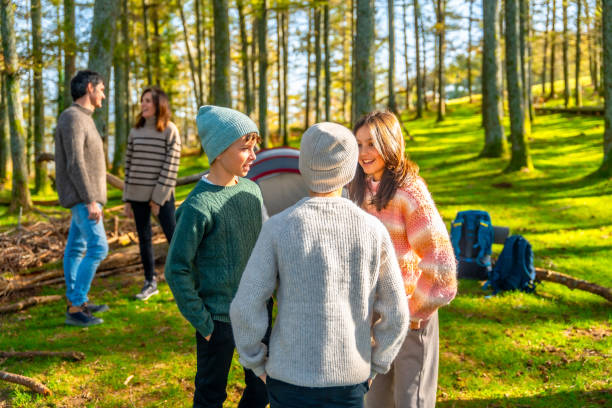 istock Family having fun during a camping in a green forest 2185349870