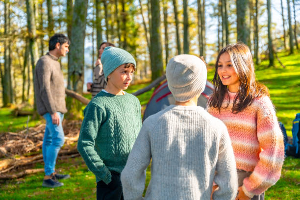 istock Children talking in the forest while camping with their parents 2185349881