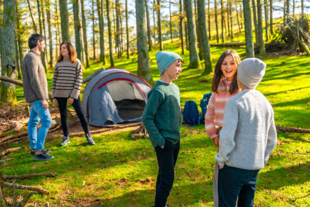 istock Parents and sons talking separately in a green forest 2185349882