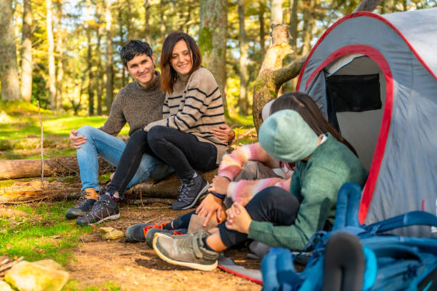 istock Family talking relaxed sitting on camping tent 2185350446