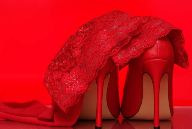 istock red stiletto heels and stockings on a red background 2185350593