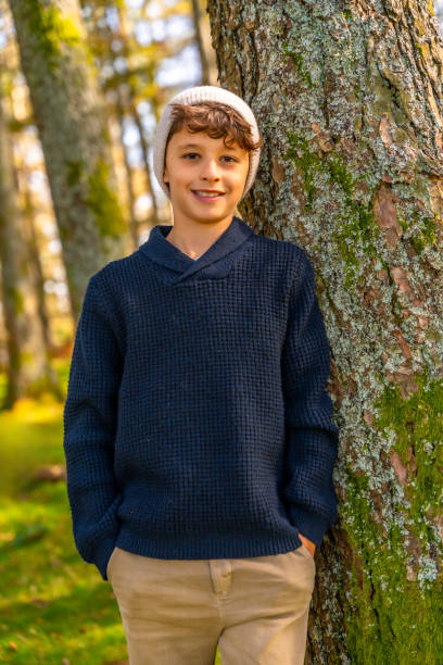 istock Urban boy leaning in a trunk in the forest 2185351413
