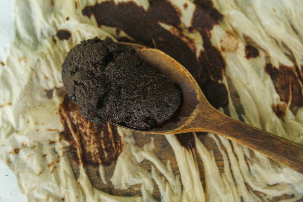 istock coffee grounds. black coffee grounds left on wooden spoon on tissue 2185351998