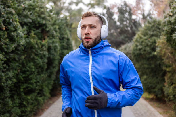 istock Runner with Headphones in Misty Park 2185353514