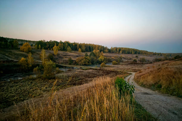 Dirt road through a field in the early morning, Russia