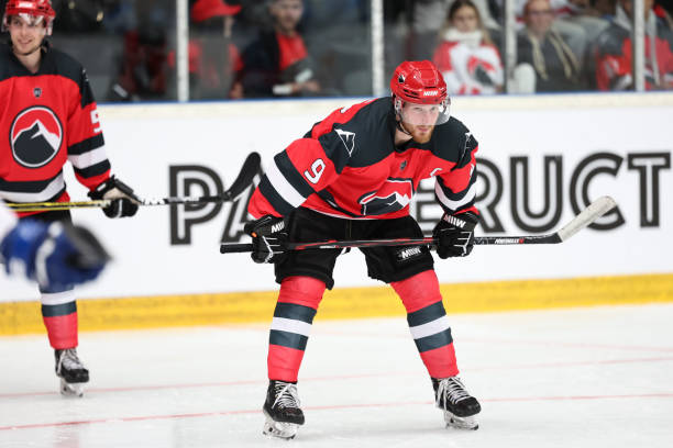 istock Ice hockey players playing on ice rink 2185357704