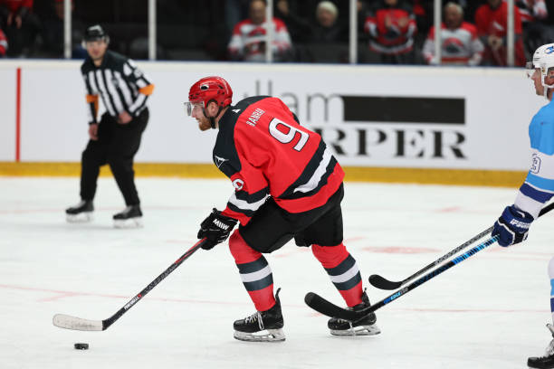 istock Ice Hockey Captain in Action: Red Team Puck Control 2185357852
