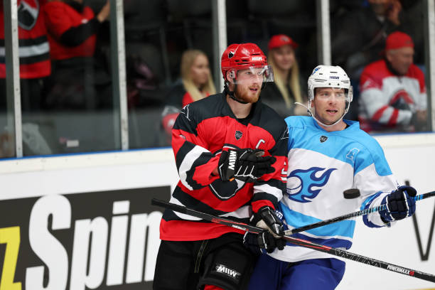 istock Ice Hockey Duel: Red Team Captain Bodychecks Blue Team Player 2185357880