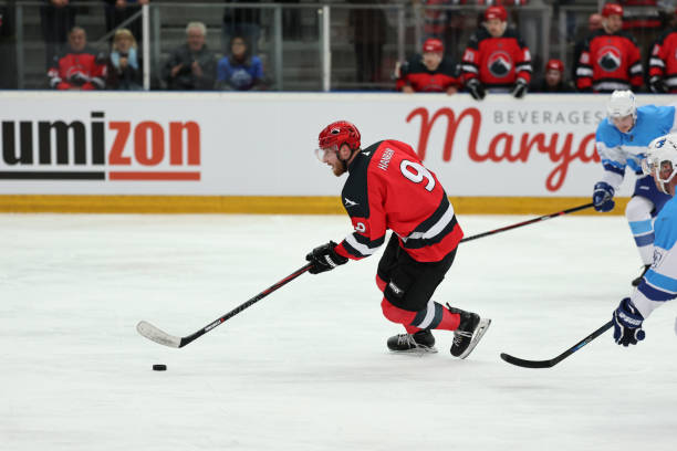 istock Red Team Hockey Player in Action 2185357892