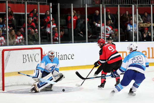 istock Ice Hockey Scoring Attempt: Red Team Challenges Blue Goalie 2185357900