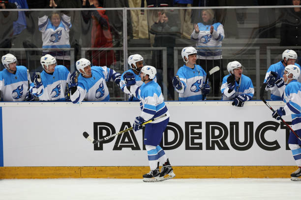 istock Ice hockey player giving high-five to teammates 2185358019