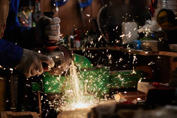 istock Metalworker grinding detail of machine 2185359011