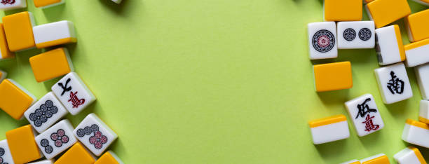 istock Mahjong tiles lined up on a green background 2185360135