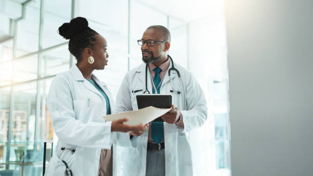 istock Teamwork, conversation and doctors with tablet, healthcare and feedback for surgery. Employees, medical and professional in hospital, tech and research with mentor, advice for schedule or digital app 2185361133