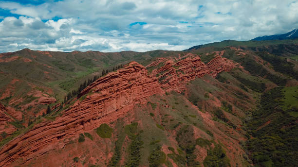 istock Stunning red rock formations rise above lush greenery in Kyrgyzstan under a blue sky 2185362175