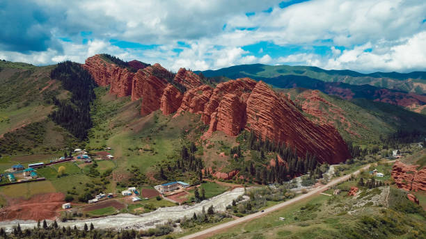 istock Stunning mountain landscape in Kyrgyzstan showcasing red rock formations and greenery 2185362193