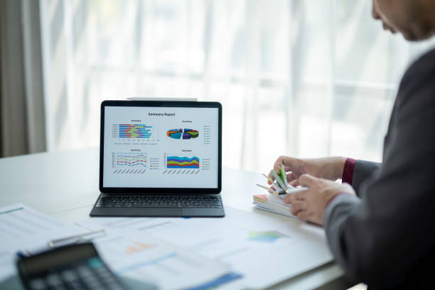 istock A man is sitting at a desk with a laptop open 2185363963