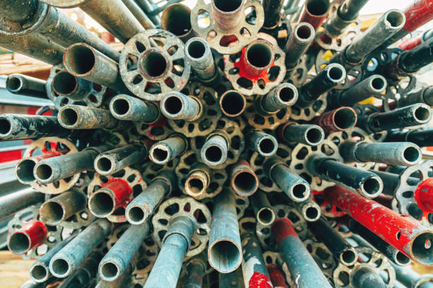 istock Stack of used worn galvanized steel scaffold tubes and pipes on construction site 2185364495