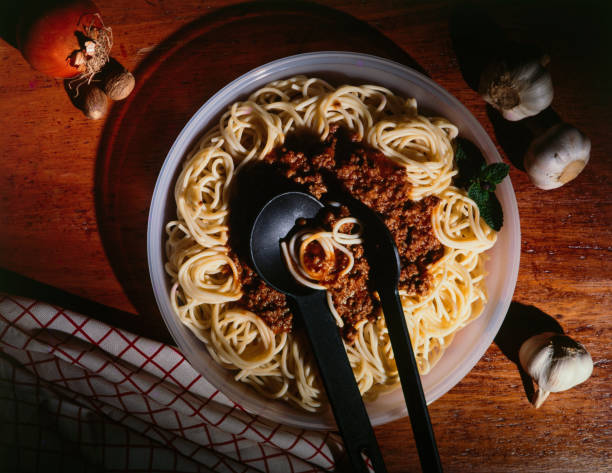 Juicy spaghetti served on a dark background