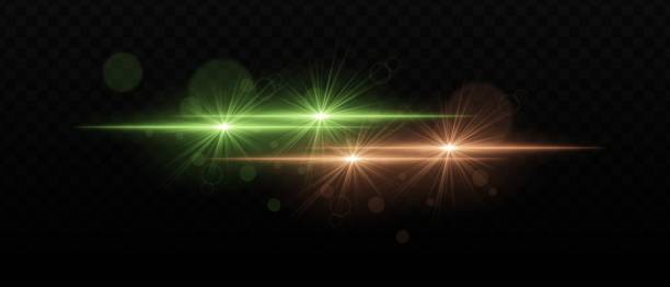 istock Green and orange light beams with radiant star-like glare and soft bokeh effects. Bright points of light and glow on a dark background, creating a layered lighting effect 2185365357