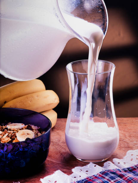jug of milk pouring over glass