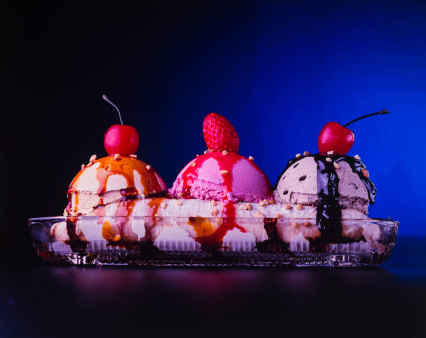 3 scoops of ice cream, banana split, strawberry, cherry, topping