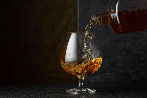 istock Pouring brandy from a bottle into a glass. 2185365610