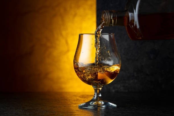 istock Pouring brandy from a bottle into a glass. 2185365615