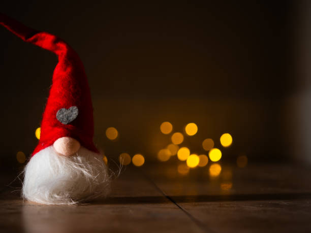 istock Christmas gnome with twinkling lights background bokeh 2185365701