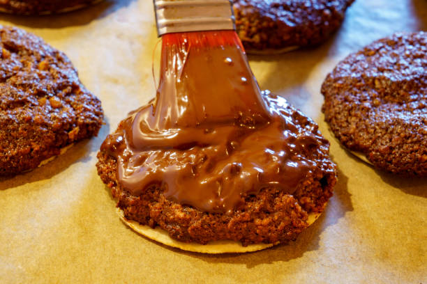 istock Making Christmas cookies at home. Nuremberg Elisen gingerbread is covered with liquid chocolate after baking 2185365729